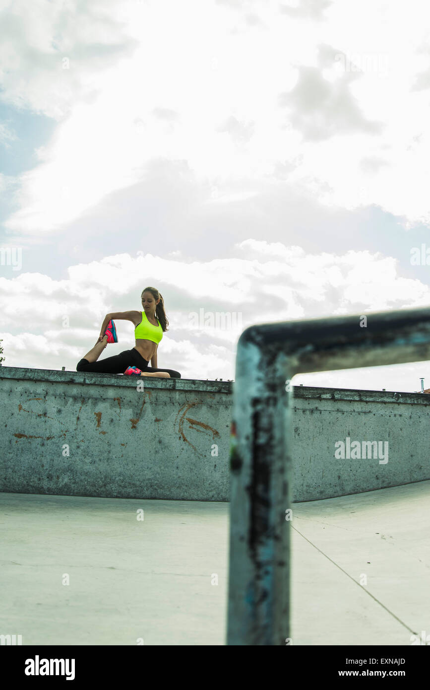 Young woman doing stretching exercises on a wall Stock Photo - Alamy