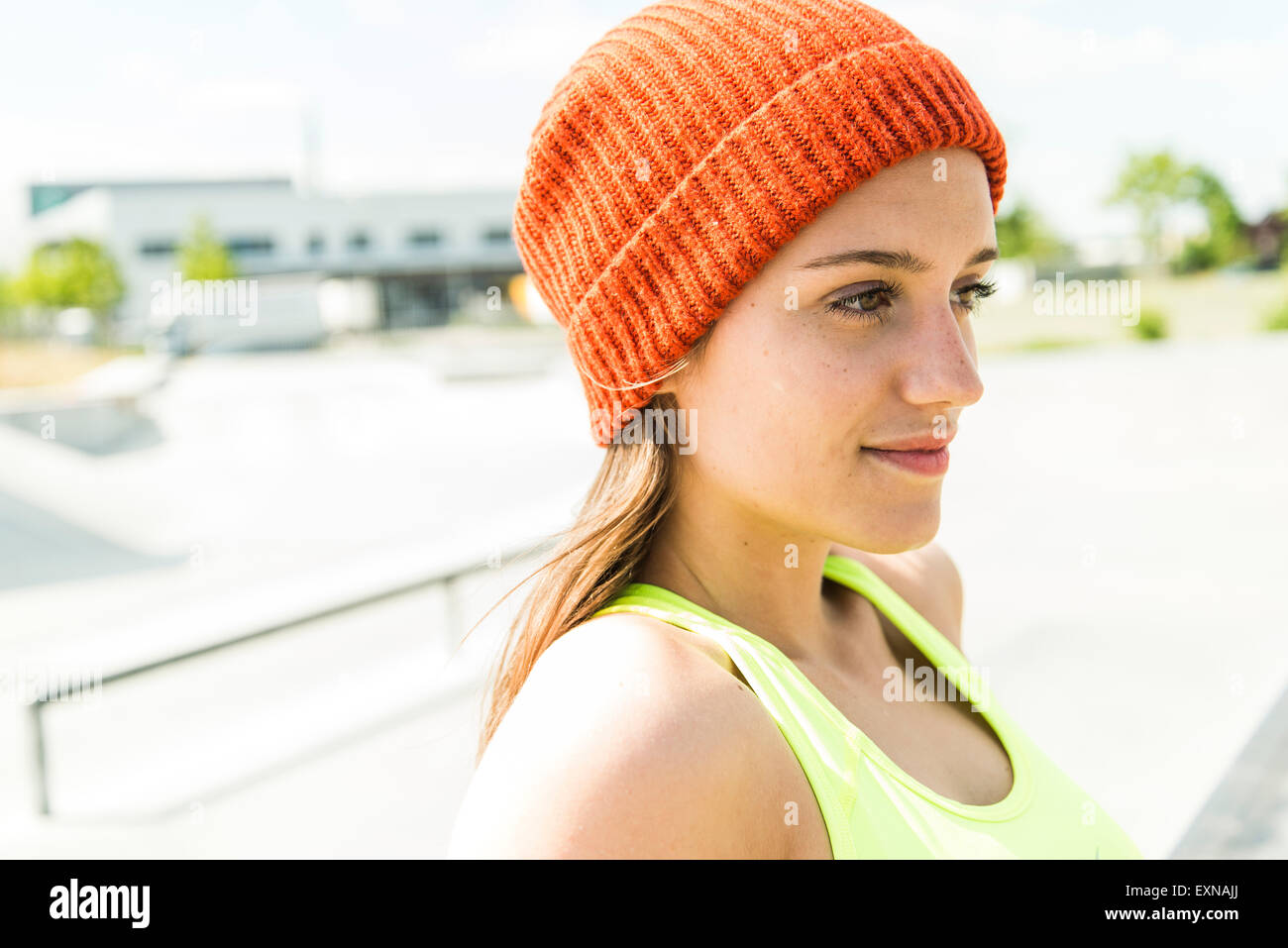 Portrait of young woman wearing orange woolly hat Stock Photo - Alamy