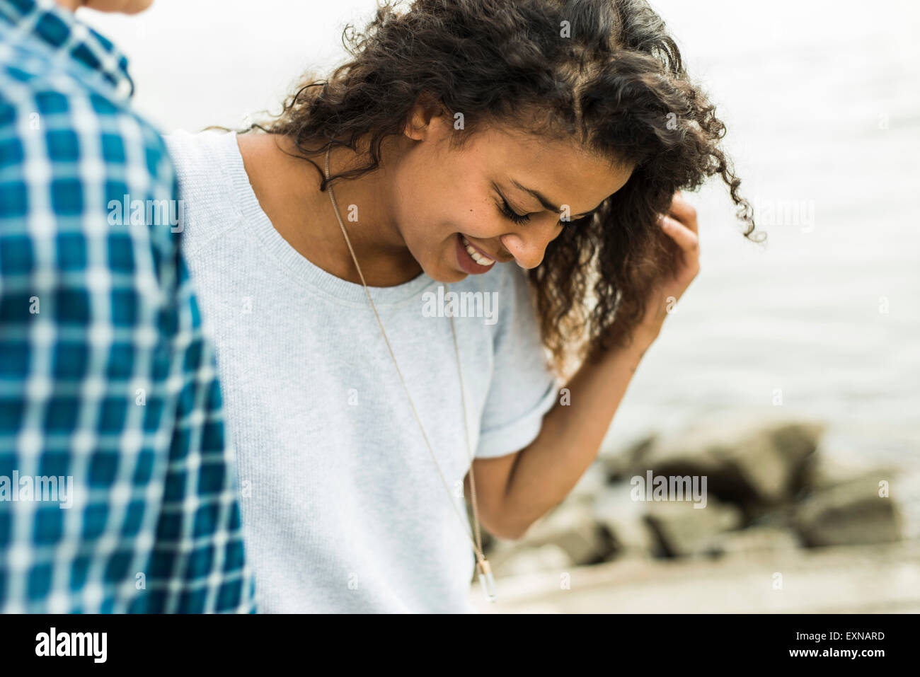 Smiling young woman with man outdoors Stock Photo - Alamy