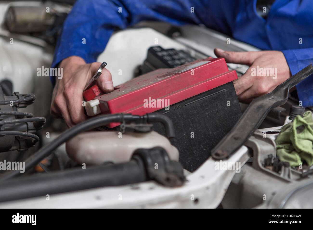 Man working on car removing battery Stock Photo Alamy