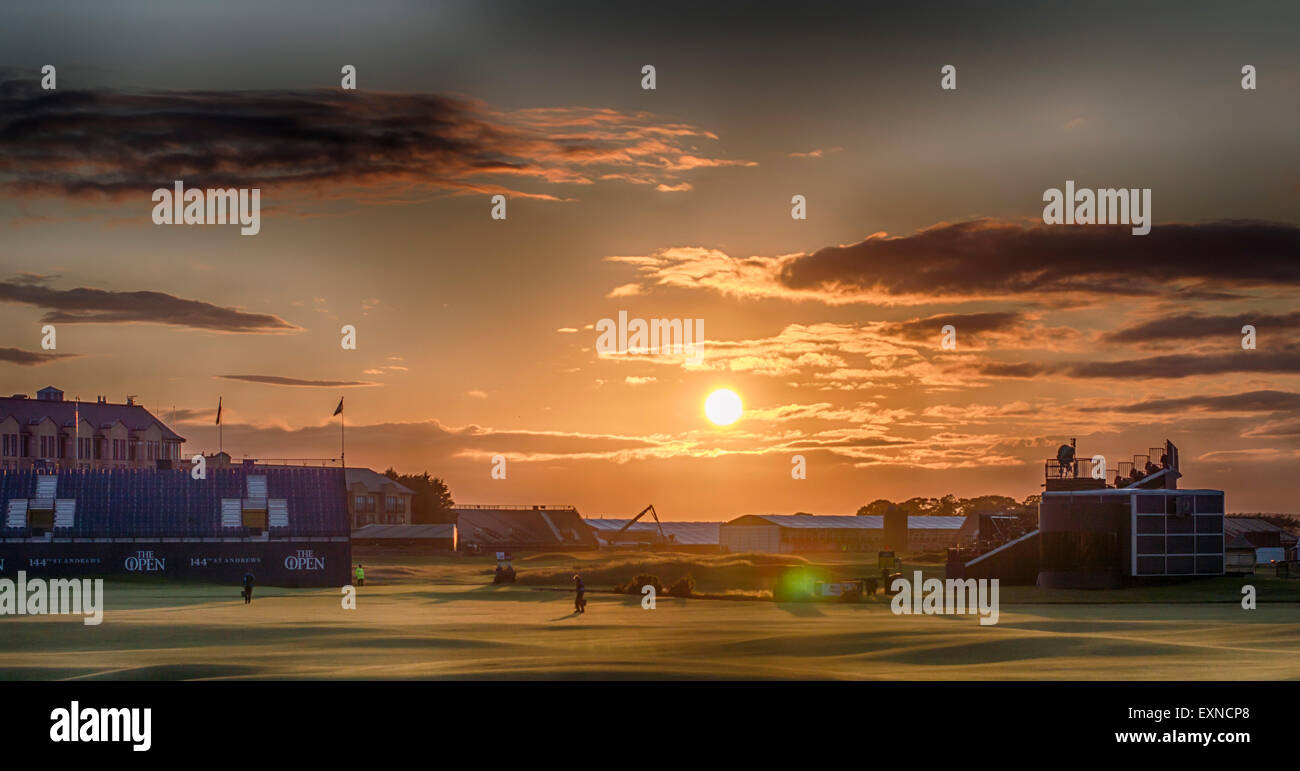 St Andrews, Fife, Scotland, UK. 15th July, 2015. Sunset over the Old Course, St Andrews as greenkeepers make their final checks on the 18th fairway. The Old Course Hotel is shown behind the stands. Credit:  Kirsty Robson/Alamy Live News Stock Photo