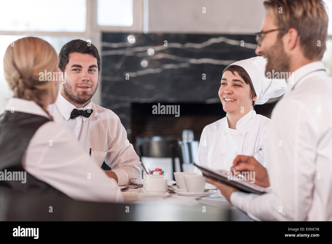 Restaurant team discussing menue and reservations Stock Photo