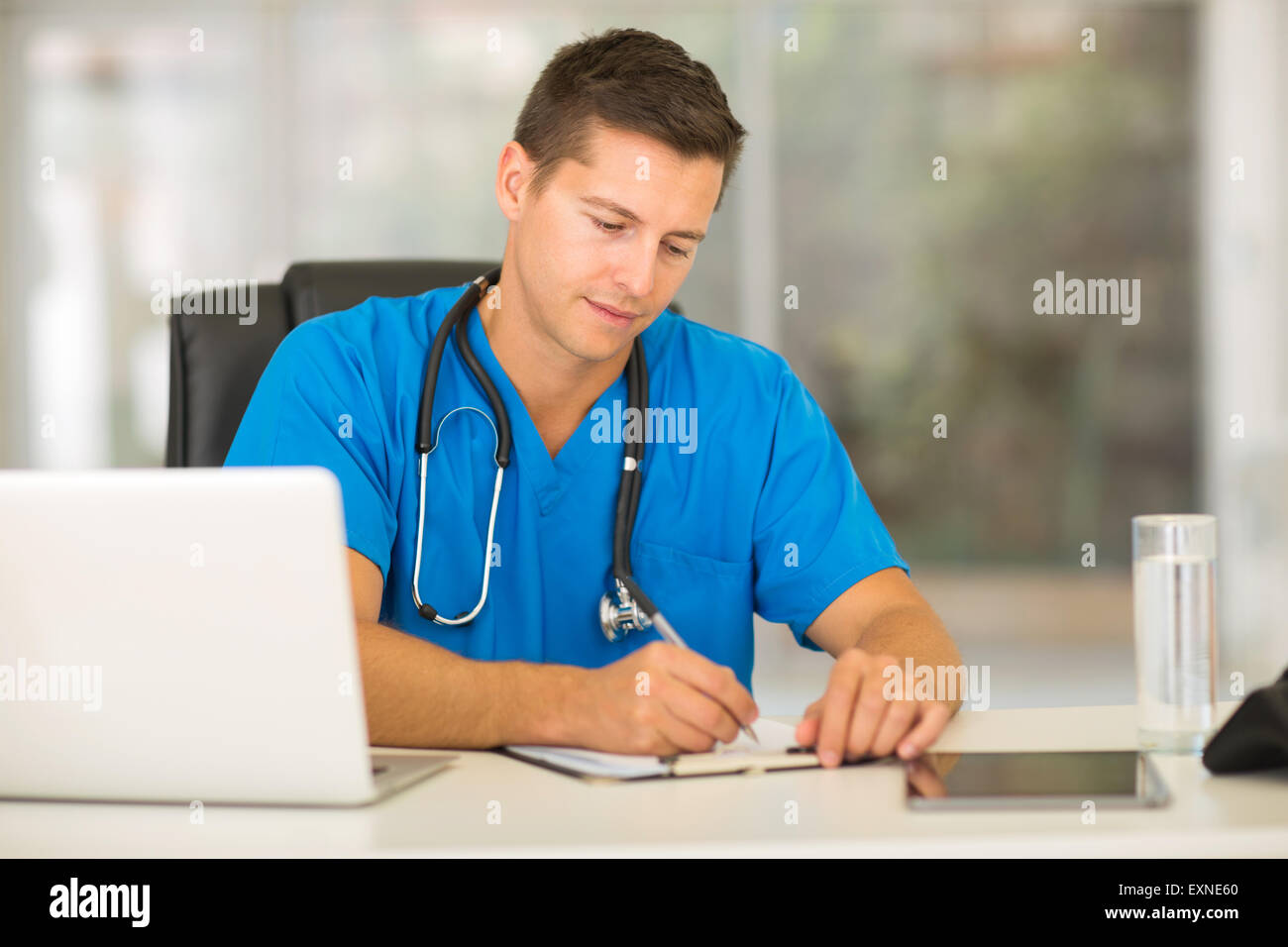 professional male nurse writing medical reports Stock Photo