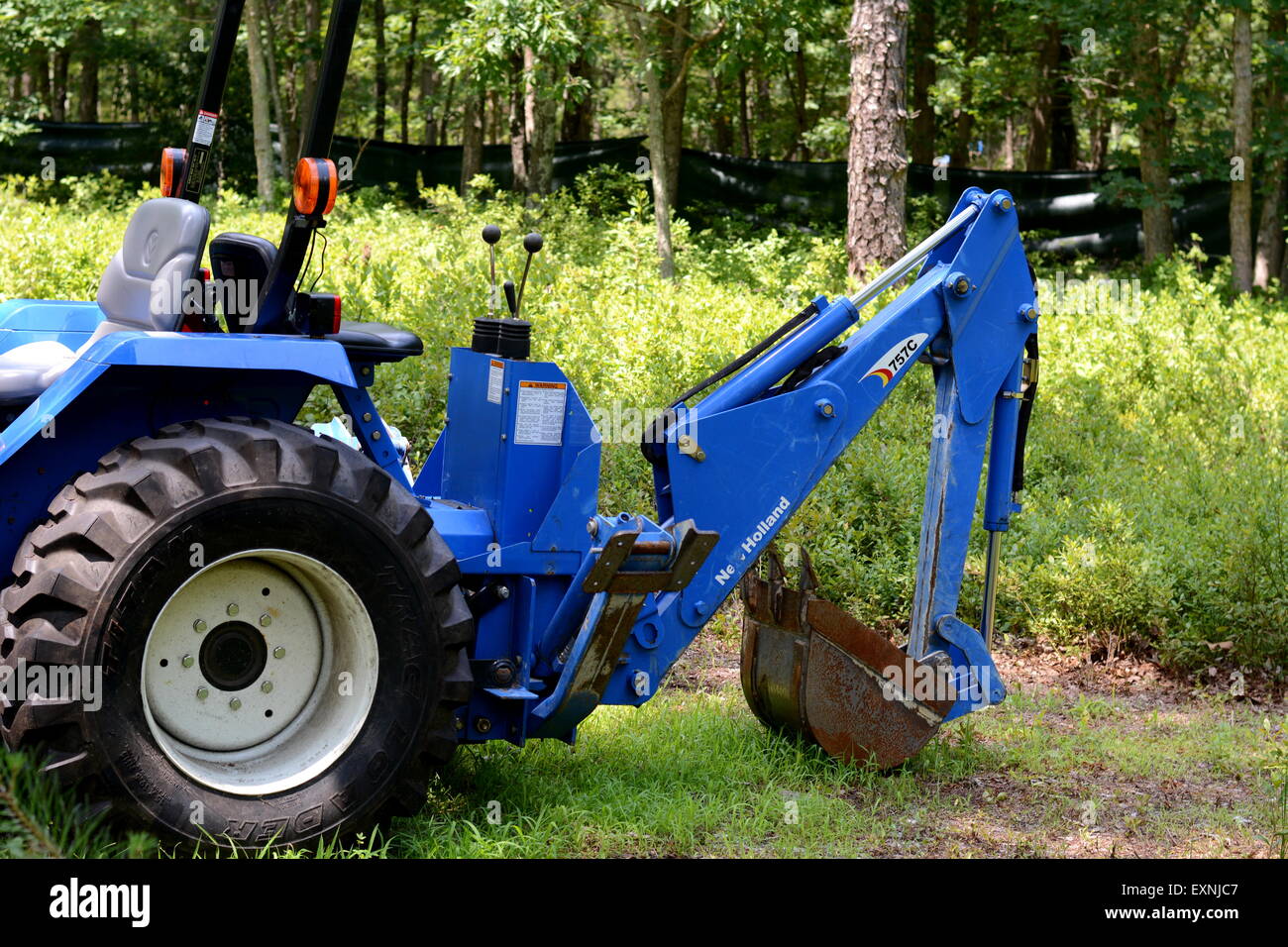 A backhoe attachment on tractor Stock Photo