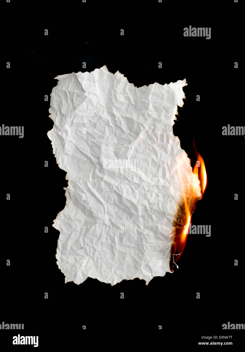 white crumpled  paper burning on black background Stock Photo