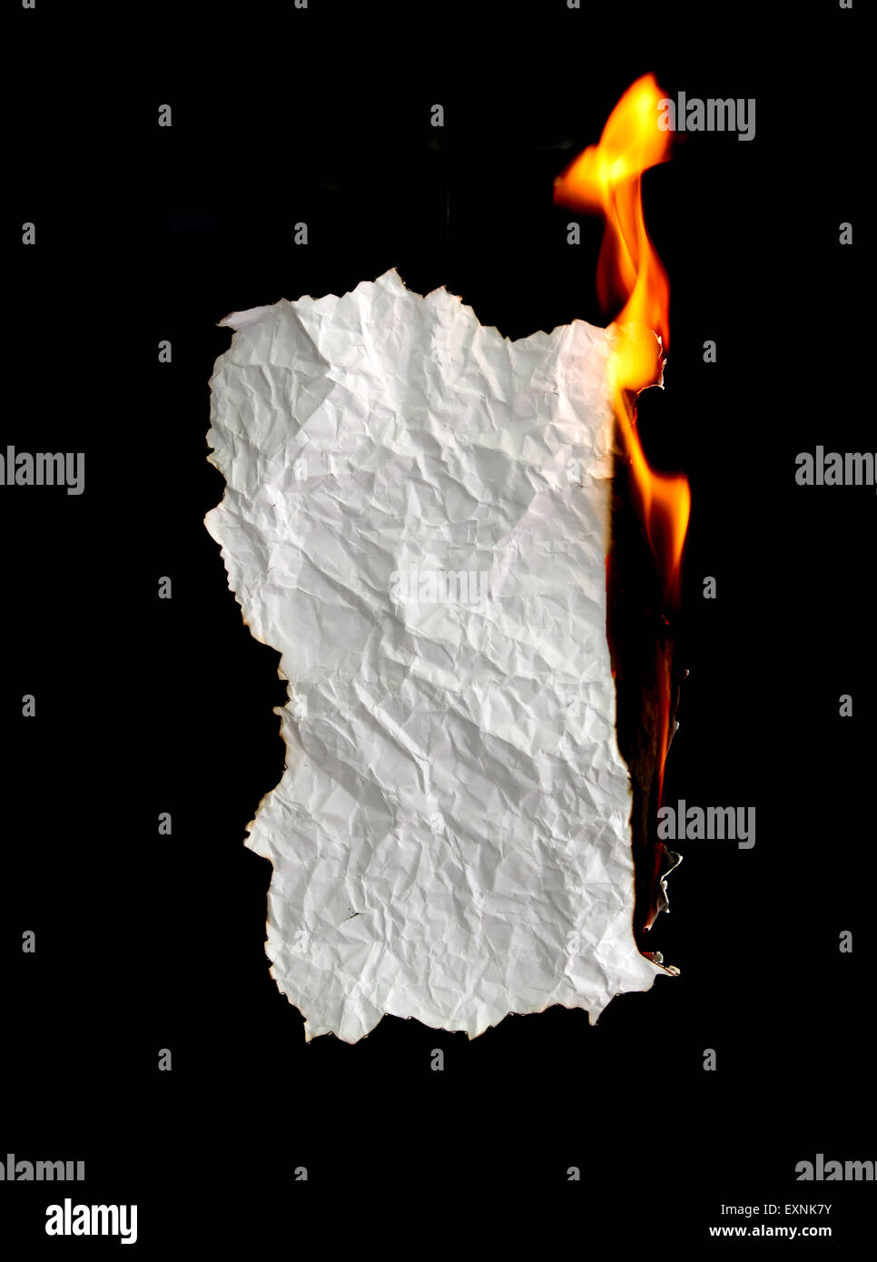 white crumpled  paper burning on black background Stock Photo