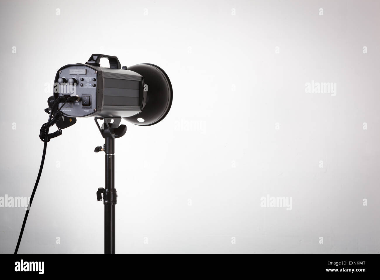 Professional photo studio strobe with reflector on tripod Stock Photo