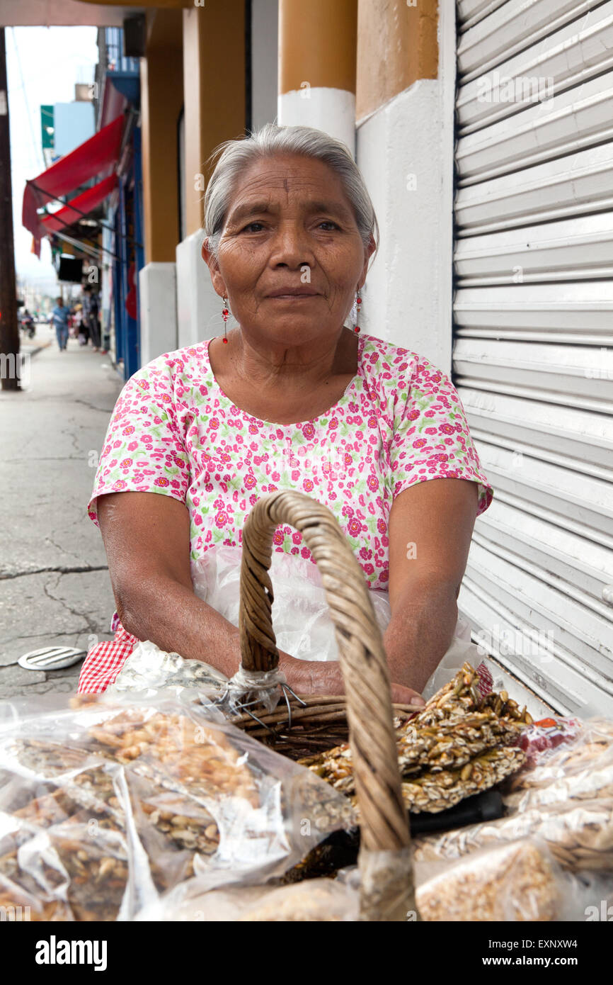 Elderly woman selling traditional mexican sweets on the street in Oaxaca, Mexico. The name of the Stock Photo