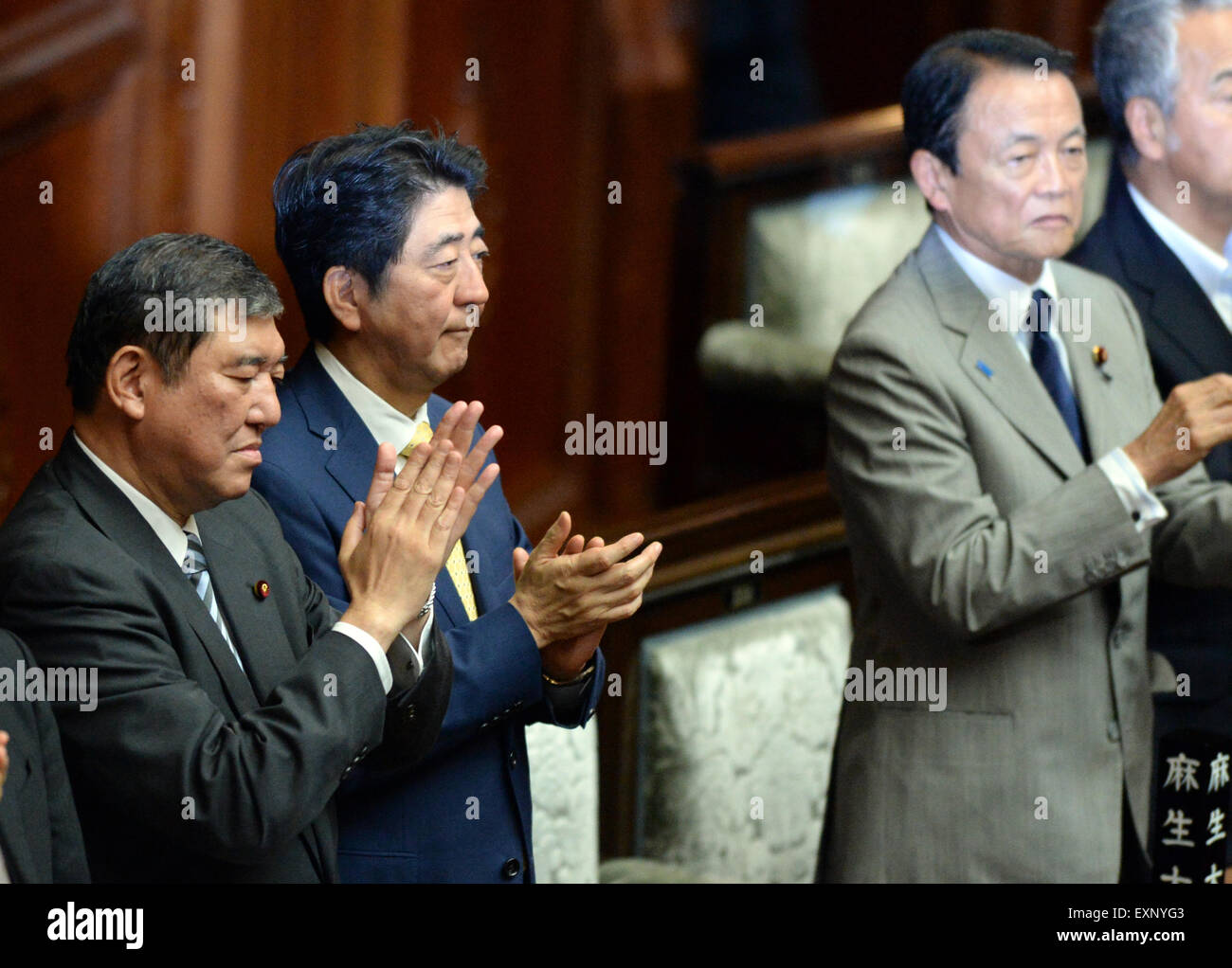 Tokyo, Japan. 16th July, 2015. Japanese Prime Minister Shinzo Abe (2nd L) claps hands after passing the controversial security bills at the lower house in Tokyo, Japan, on July 16, 2015. Japan's ruling coalition led by Prime Minister Shinzo Abe on Thursday rammed through a series of controversial security bills in the all-powerful lower house of the nation's Diet amid strong public opposition, marking the most significant overturn of the nation's 'purely defensive' defense posture. Credit:  Ma Ping/Xinhua/Alamy Live News Stock Photo