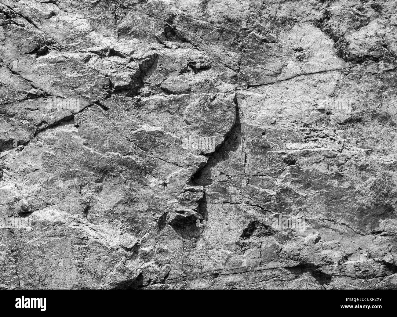 Rough dark gray rock wall, natural stone surface background texture Stock Photo