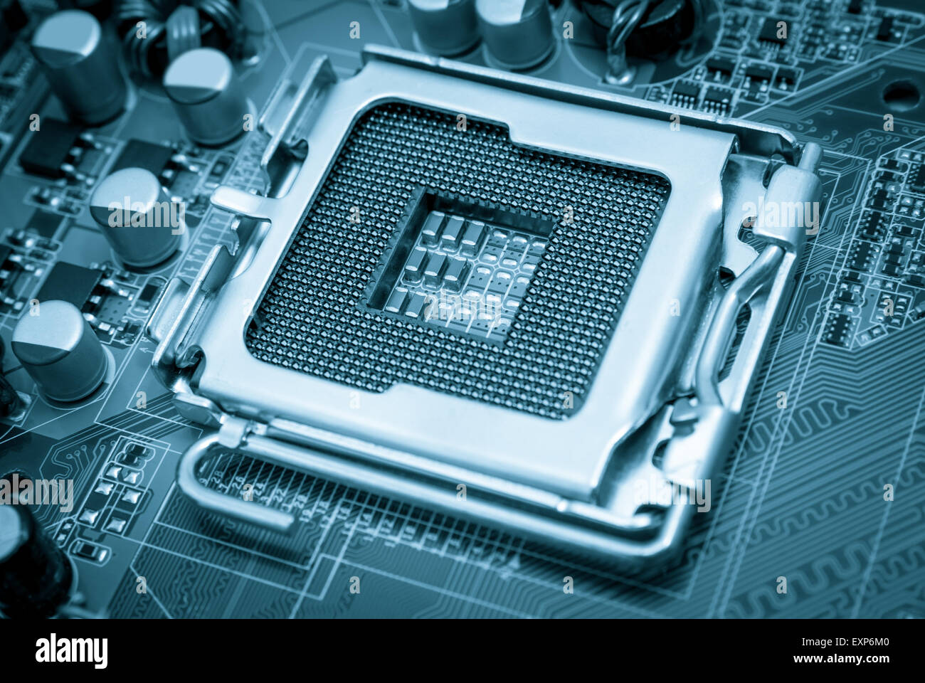 Empty CPU processor socket with pins on motherboard toned blue Stock Photo