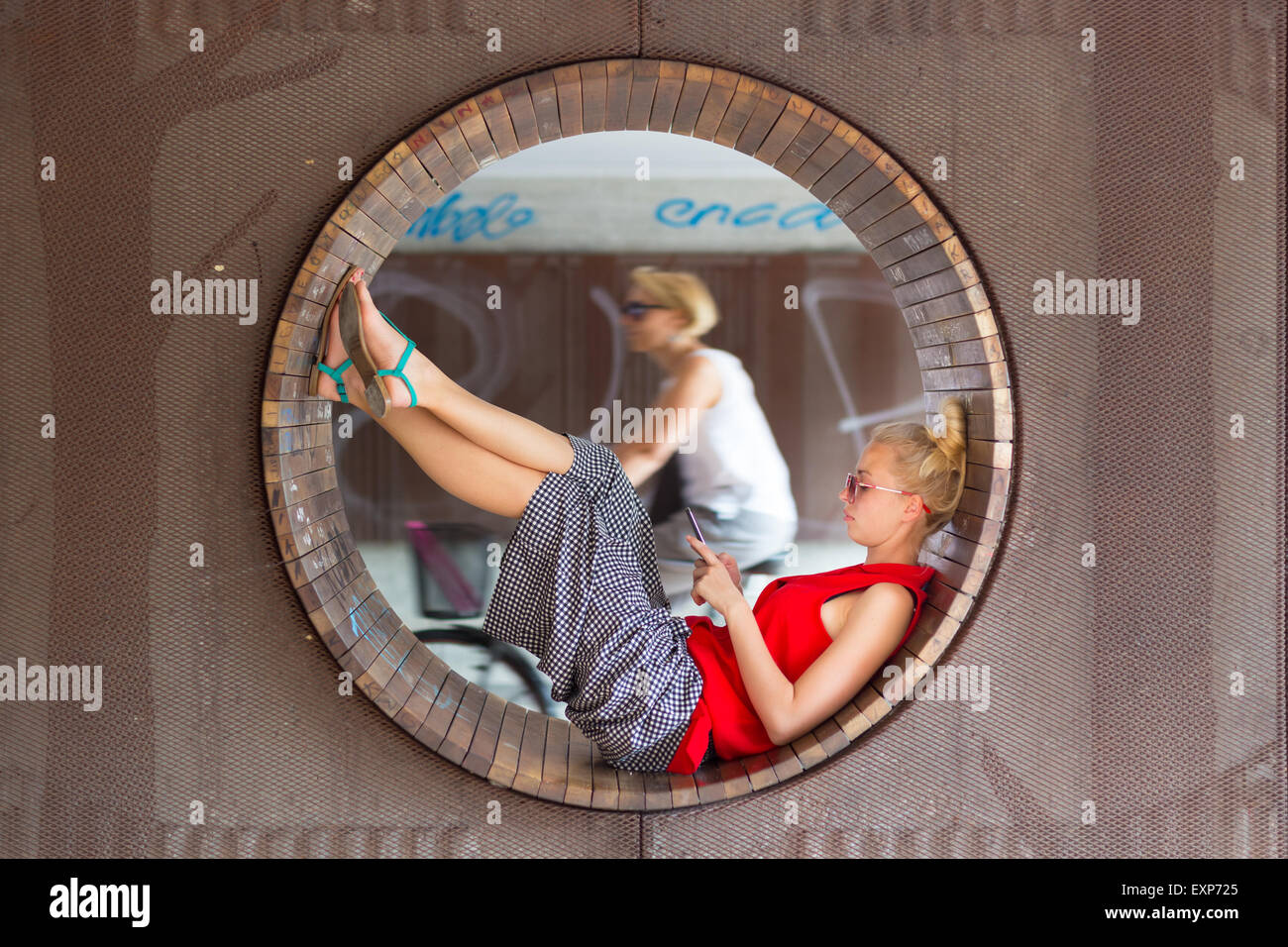 Young cheerful woman using smarthphone. Stock Photo