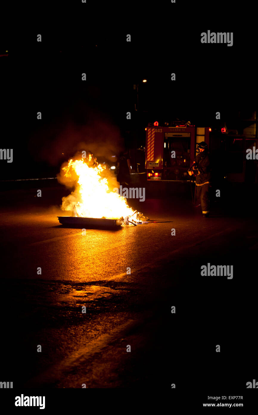 Athens, Greece. 15th July, 2015. Fireman distinguish damage caused by Anarchists during the Anti austerity protests in Athens while the 3rd Bailout vote is discussed in the Greek Parliament. Credit:  Martin Garnham/Alamy Live News Stock Photo