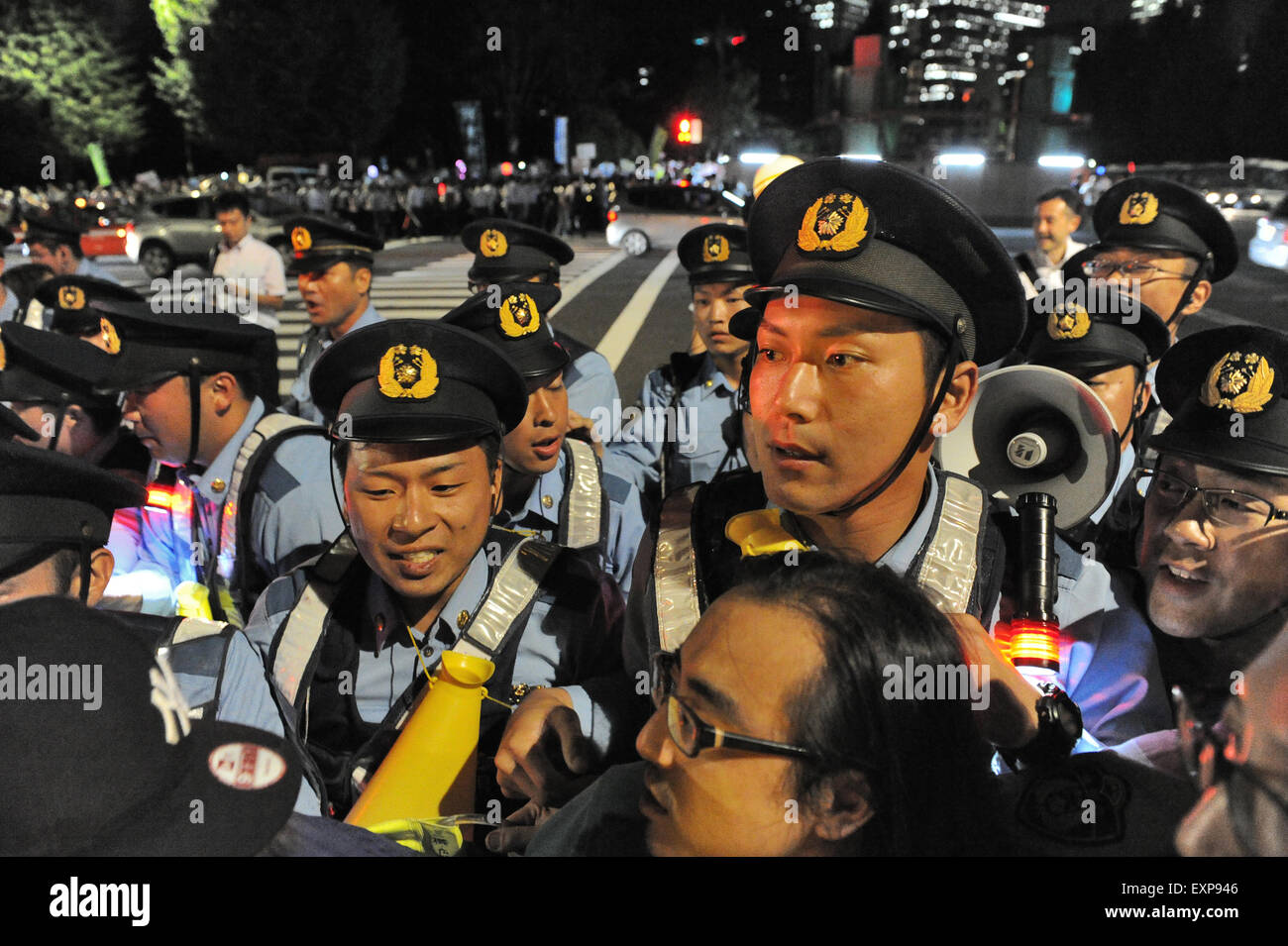 A scene at a protest against Japanese Prime Minister Abe's security policies at Japan's parliament in Tokyo on July 15, 2015. According to the organizers, Students Emergency Action for Liberal Democracy (SEALDs), some 100,000 people participated which police had much trouble to control. Earlier in the day, a special committee of the Lower House had cleared a bill for voting. Stock Photo