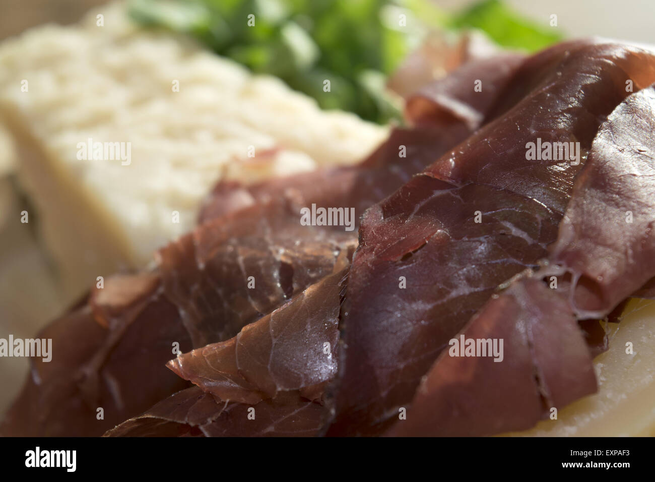 italian appetiser and second course: bresaola and parmesan Stock Photo