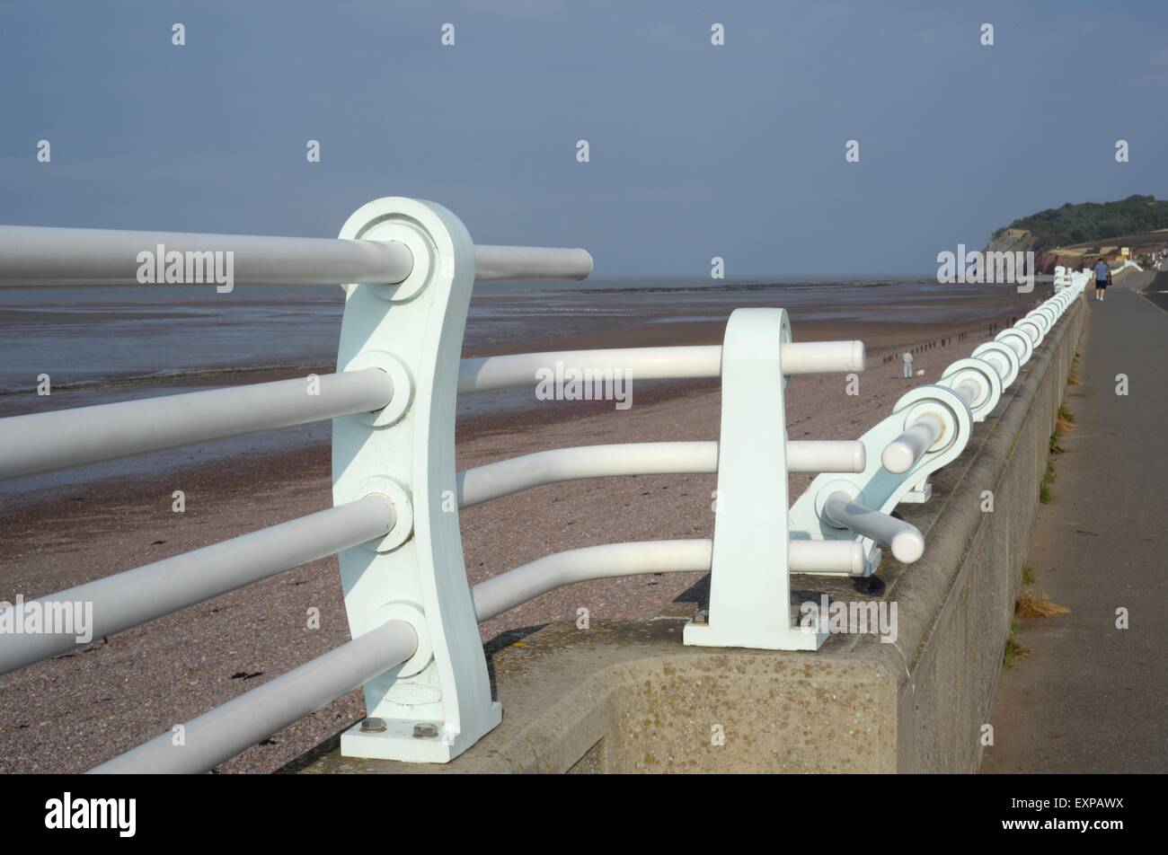Promenade at Blue Anchor, Somerset, UK with blue railings on the sea wall Stock Photo