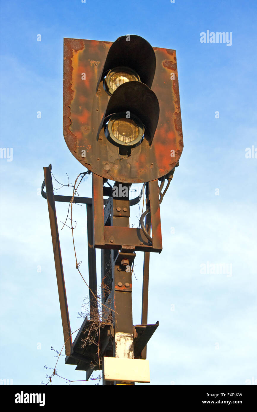 Old rusty Railway traffic lights over blue sky Stock Photo