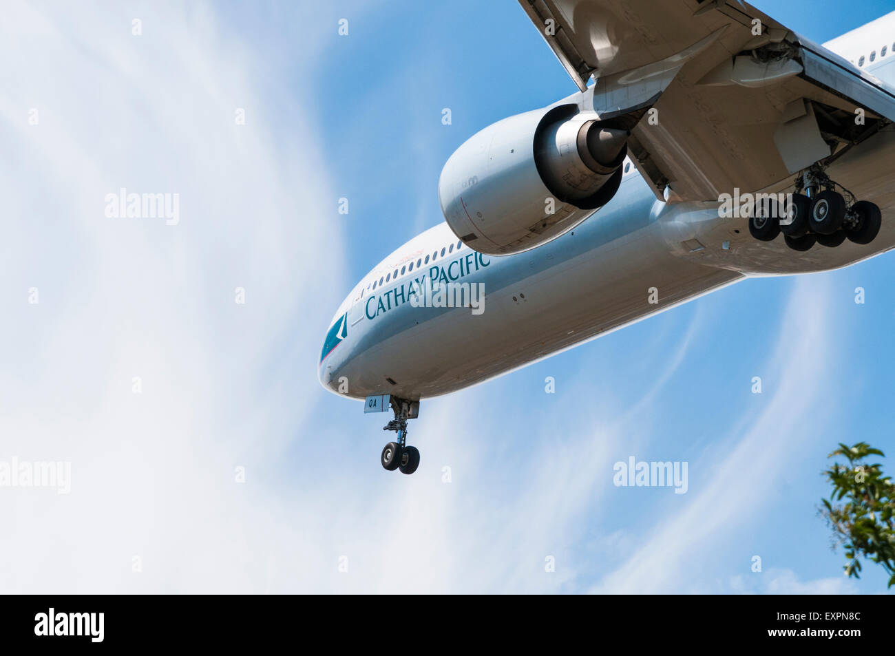 Cathay Pacific Boeing 777 aeroplane flying overhead on approach to land at London Heathrow Stock Photo