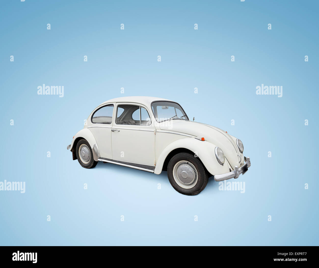 Vintage Volkswagen Beetle car isolated on blue background. Please not: the car is NOT in perfect condition. Stock Photo