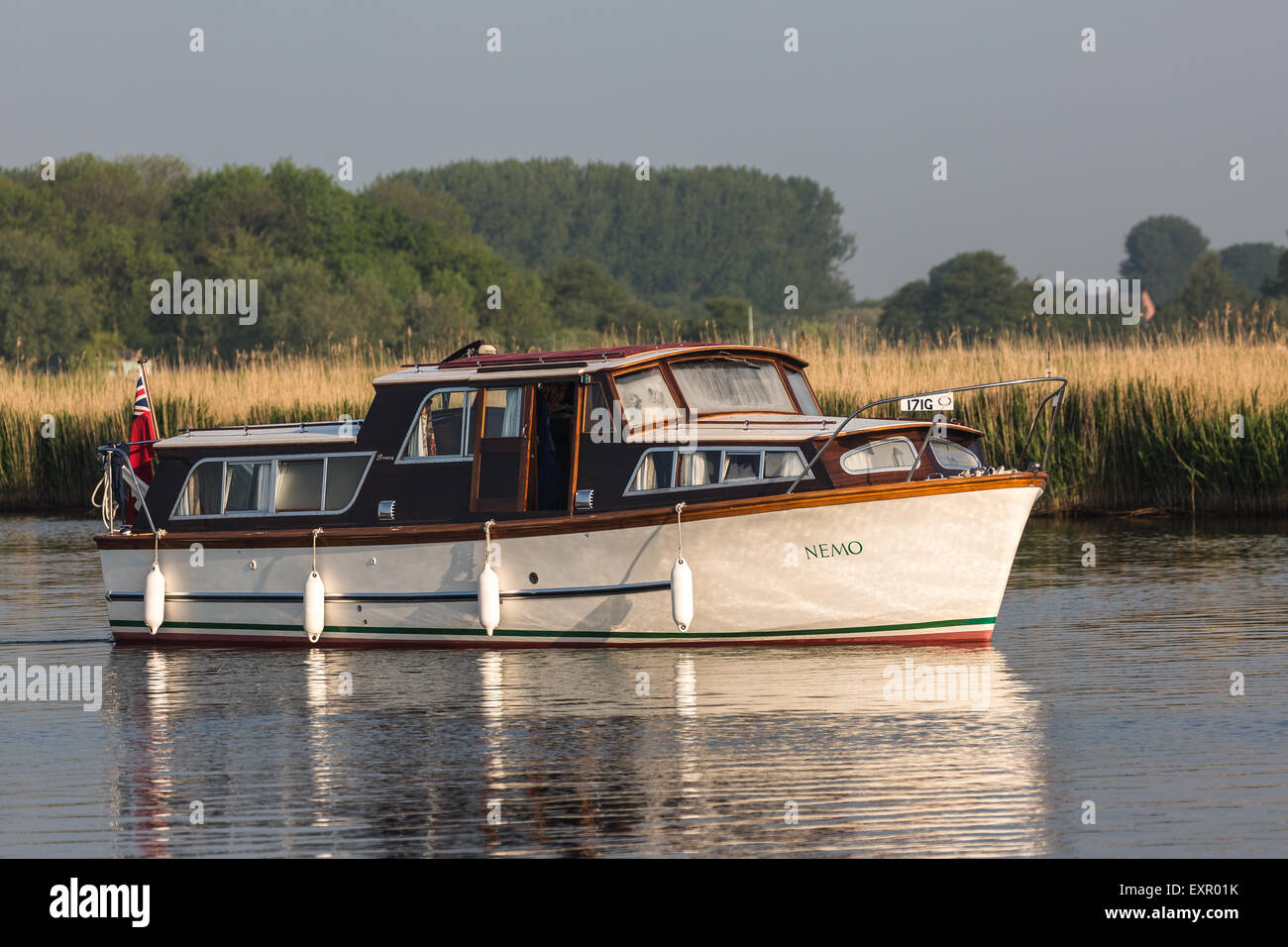 cruising on the norfolk broads early morning .summer vacation  UK Stock Photo