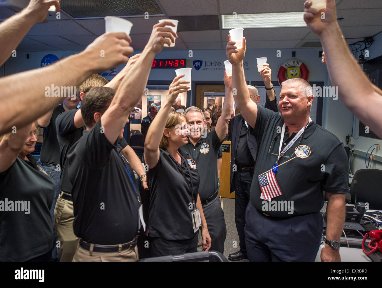 Members of the New Horizons team celebrate after confirming the spacecraft successfully completed the flyby of Pluto at the Johns Hopkins University Applied Physics Laboratory July 14, 2015 in Laurel, Maryland. Stock Photo