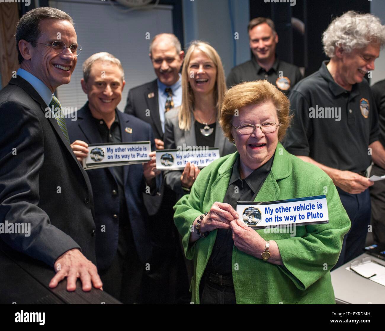 U.S. Senator Barbara Mikulski holds a bumper sticker given to her by members of the New Horizons team at the Johns Hopkins University Applied Physics Laboratory July 13, 2015 in Laurel, Maryland. Joining her are: (L-R) APL Director Ralph Semmel, New Horizons Principal Investigator Alan Stern SwRI, Associate Administrator for the Science Mission Directorate John Grunsfeld and NASA Deputy Administrator Dava Newman. Stock Photo