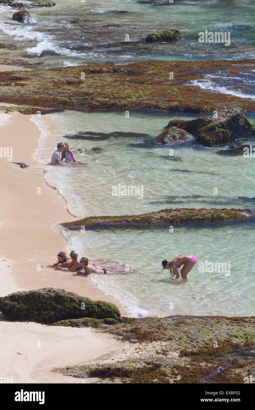 Tourists having recreational time on Padang-padang beach in Labuan Sait, South Kuta, Badung, Bali, Indonesia. Stock Photo