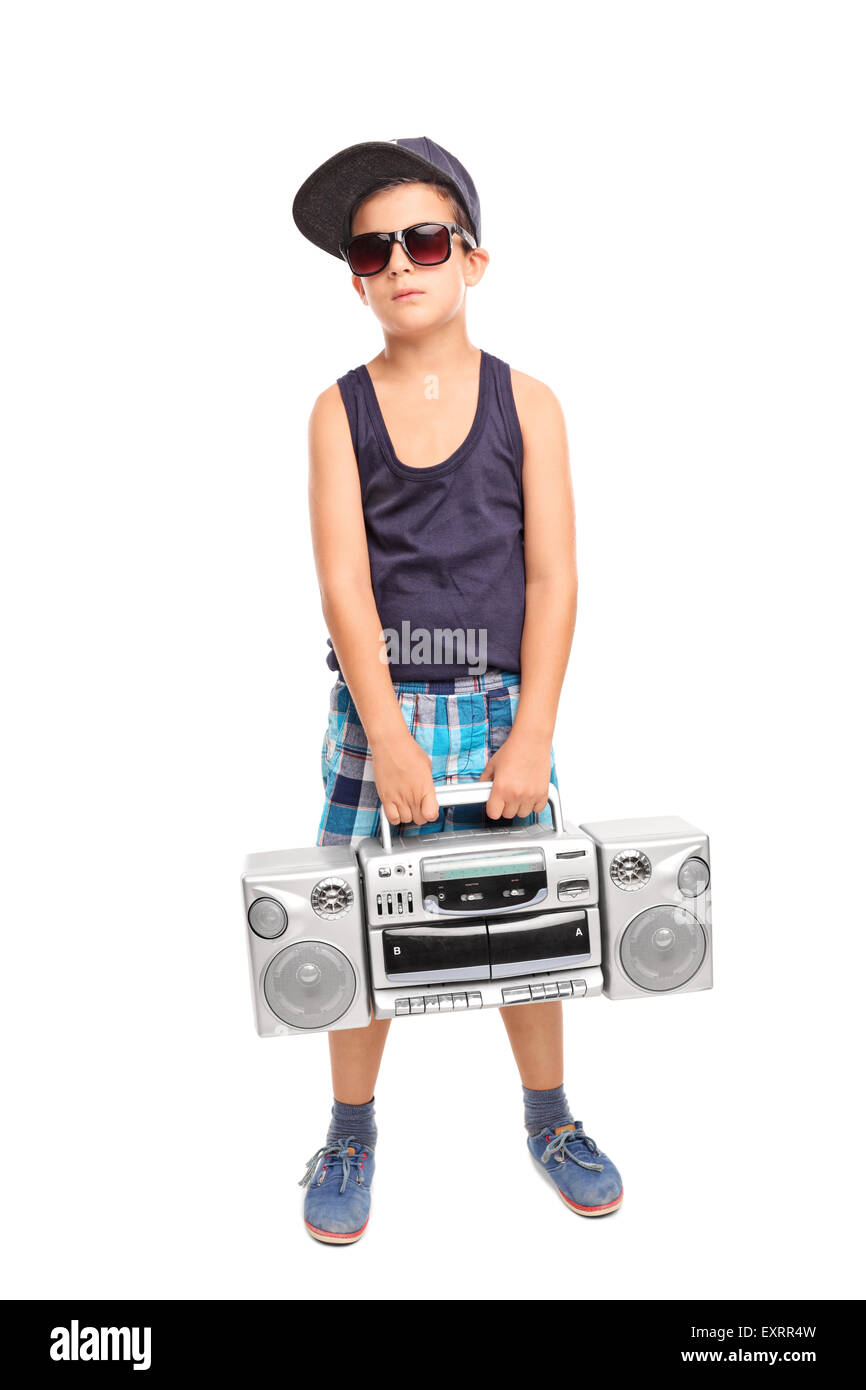 Full length portrait of a cool kid in hip-hop clothes holding a radio and looking at the camera isolated on white background Stock Photo