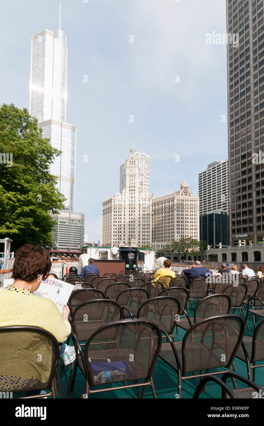 Tourists aboard a Chicago Architecture Foundation river cruise with the Trump Tower and Wrigley Building in background. Stock Photo
