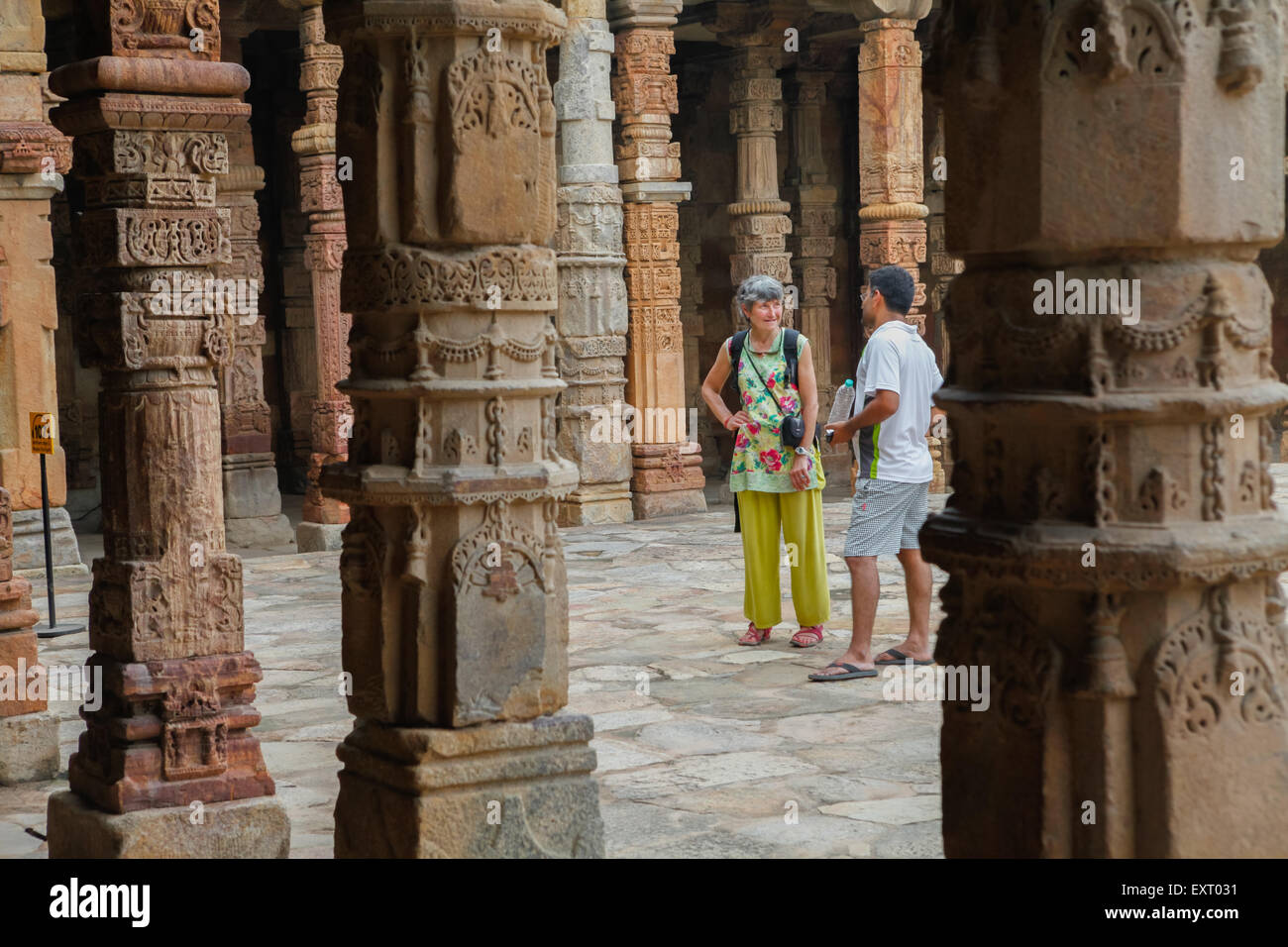 Western tourist and travel guide at Qutab Minar, South Delhi, India. Stock Photo