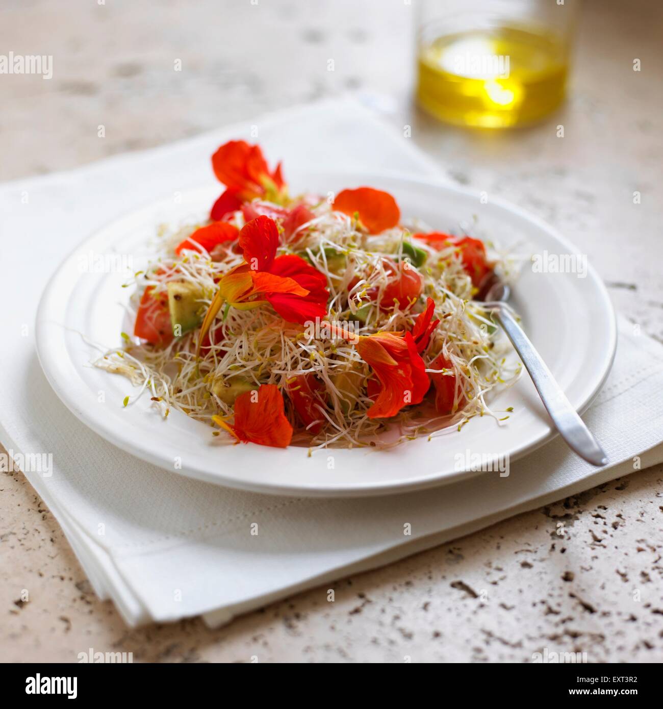 Salad of nasturtium flowers and sprouts on a plate Stock Photo