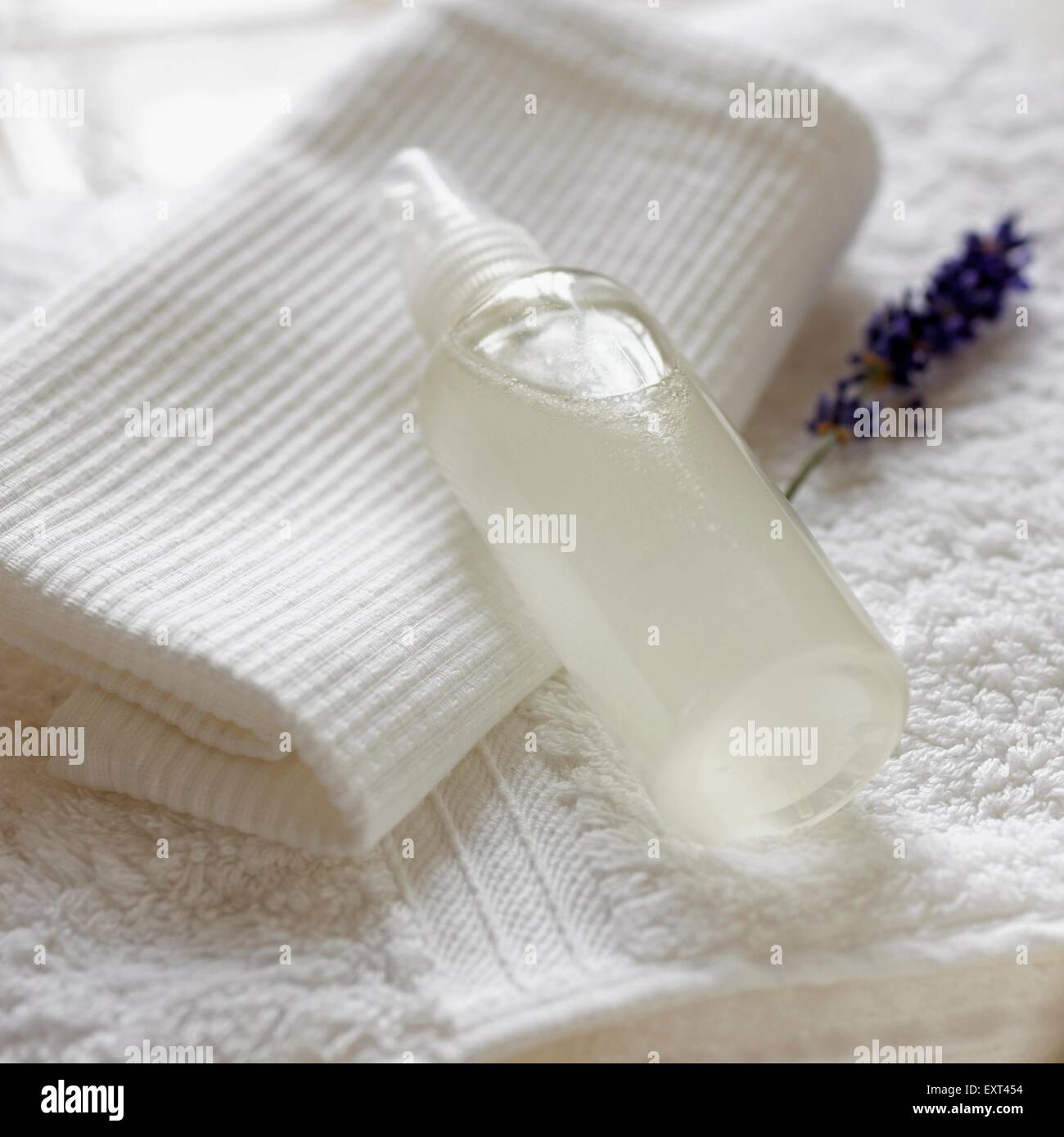 Bottle of witch hazel (hamamelis) and lavender deodorant, on a towel, close-up Stock Photo