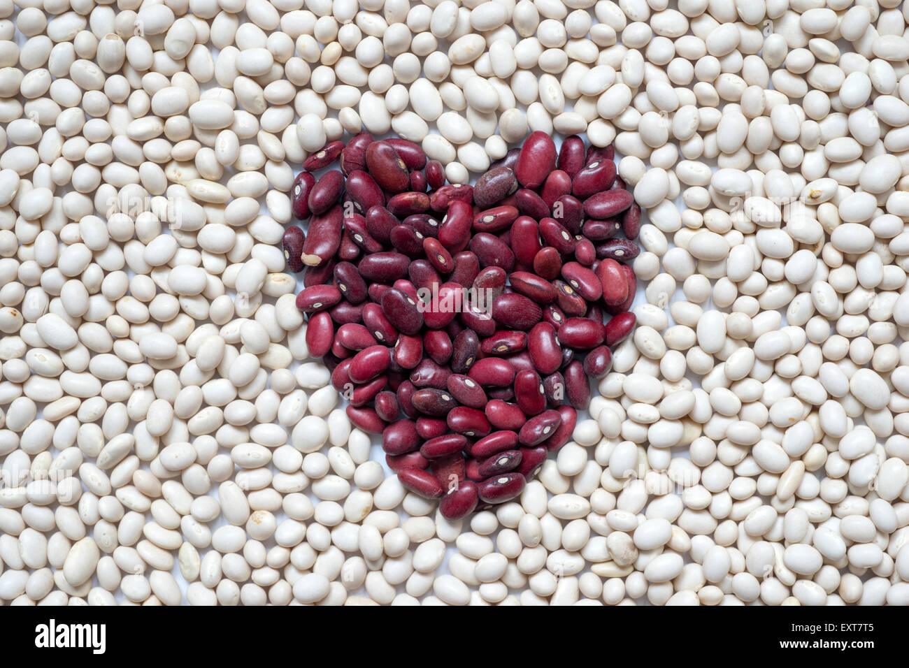 red and white kidney beans background with shape of heart Stock Photo