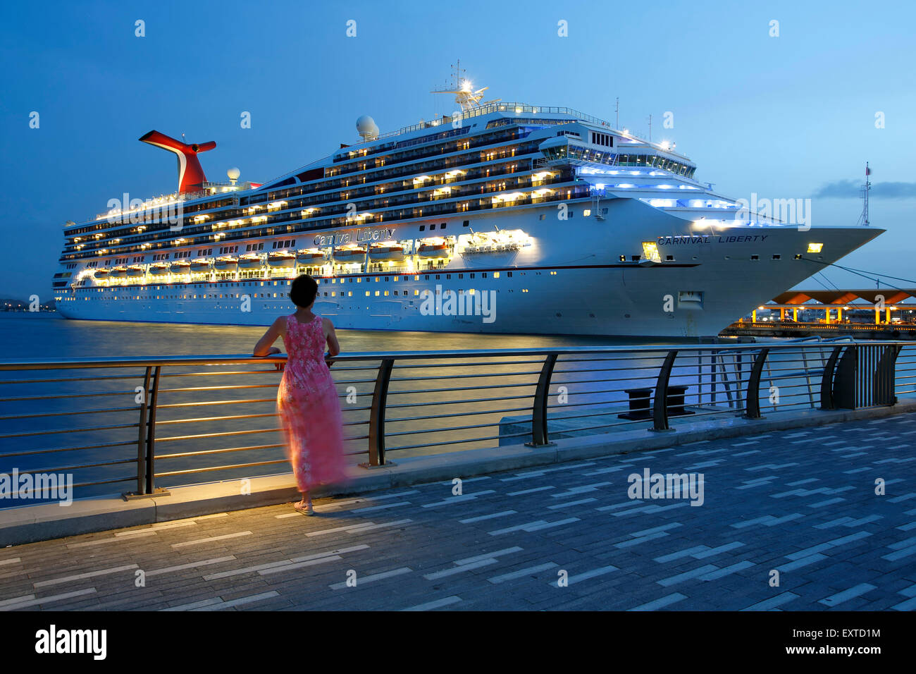 Woman admiring cruise ship from  Bahia Urbana (Urban Bay), Old San Juan, Puerto Rico Stock Photo