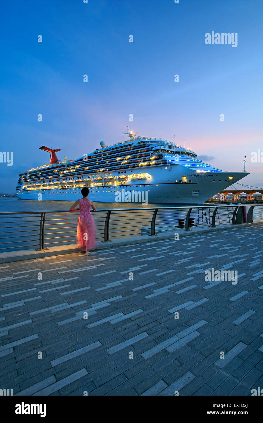 Woman admiring cruise ship from  Bahia Urbana (Urban Bay), Old San Juan, Puerto Rico Stock Photo