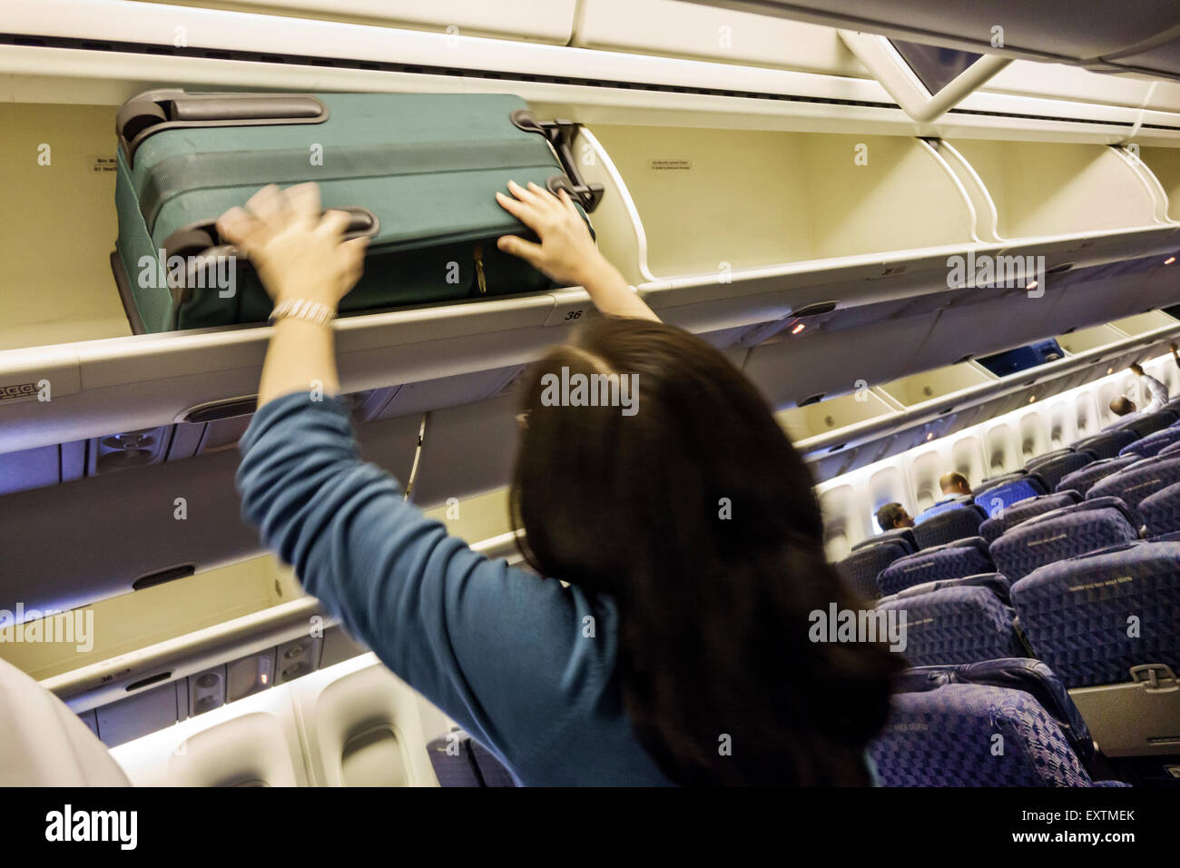 Dallas Texas,Dallas Ft. Fort Worth International Airport,DFW,American Airlines,aircraft,cabin,boarding,departure,overhead bin,stowing bag,passenger pa Stock Photo