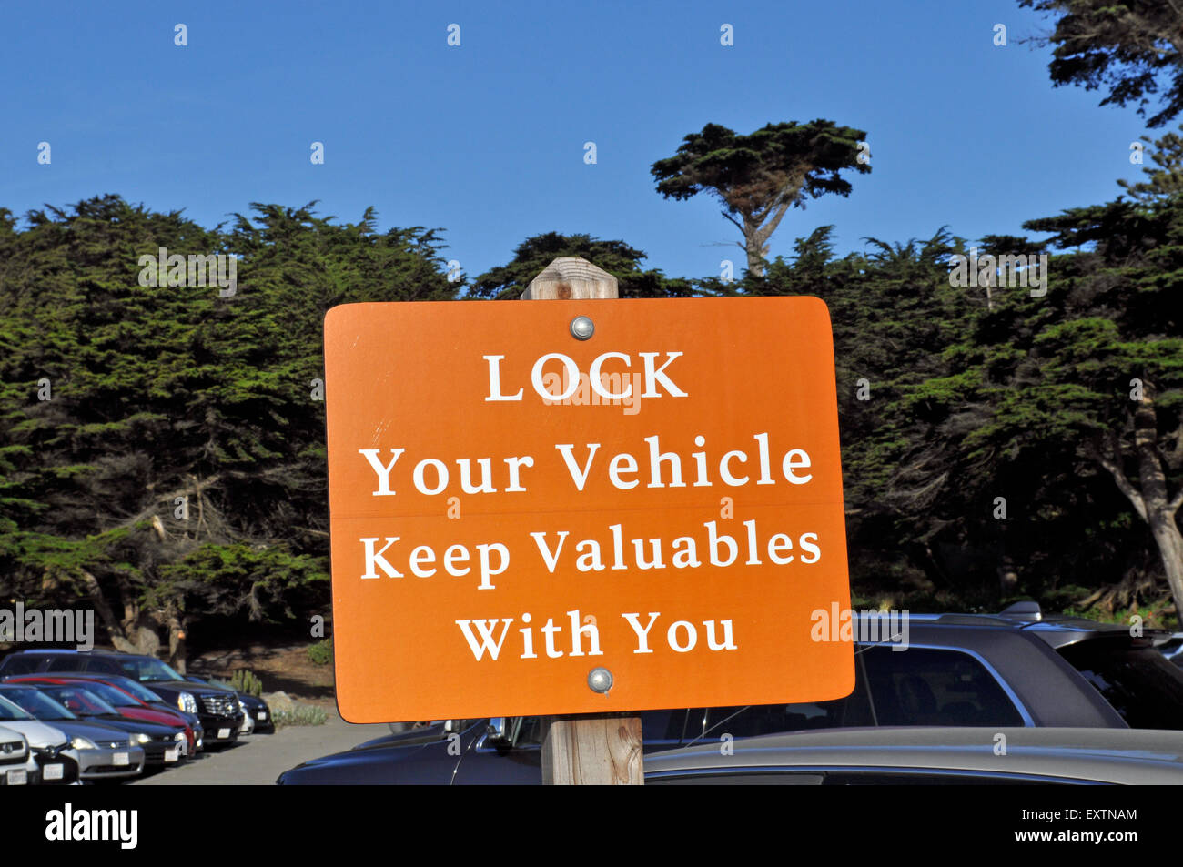 warning sign to lock your vehicles keep valuables with you, California parking lot Stock Photo