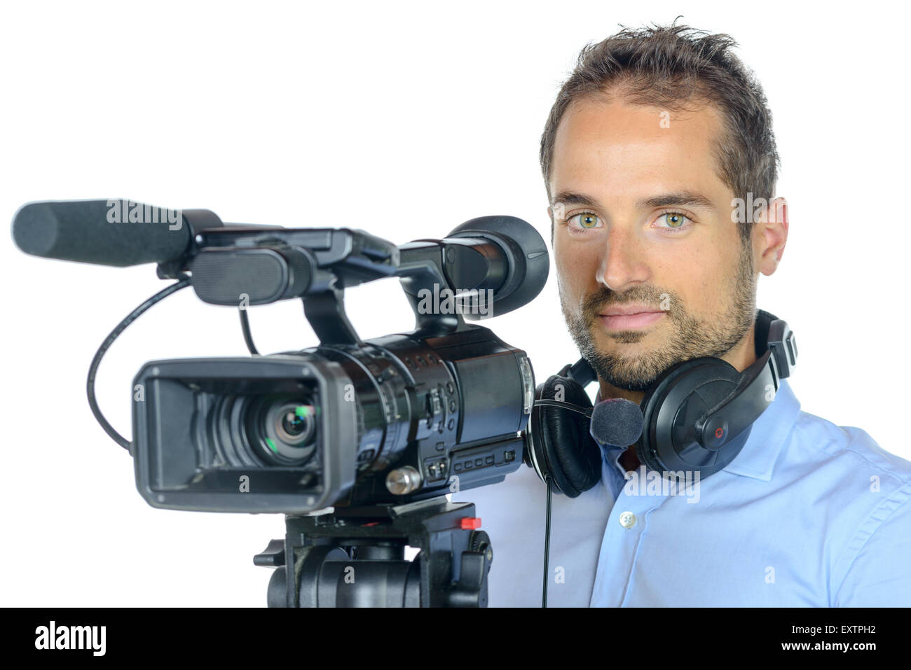 Young man with professional movie camera on white background Stock