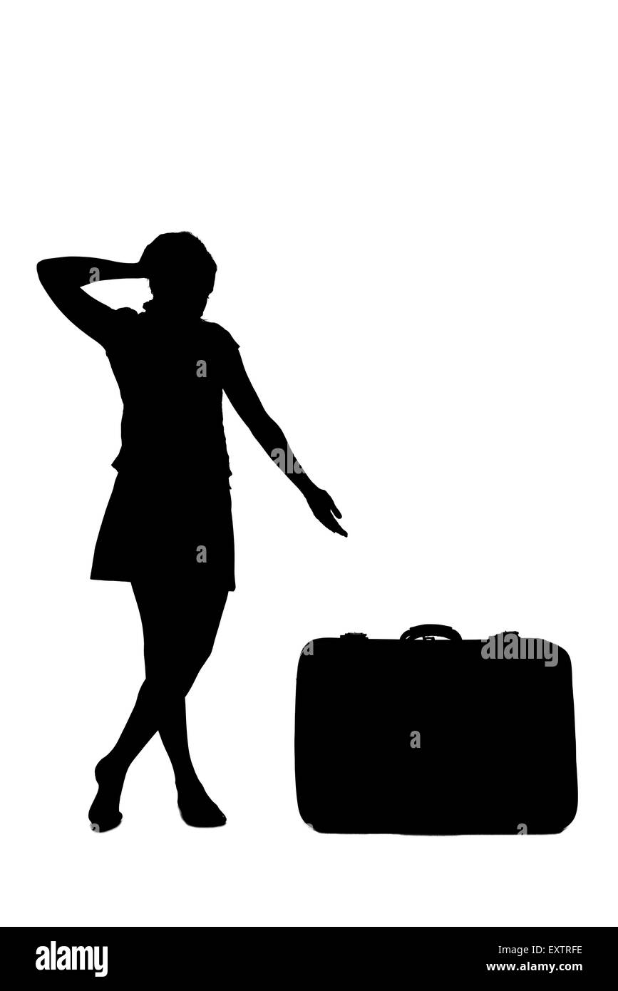 woman silhouette - pointing at a luggage Stock Photo