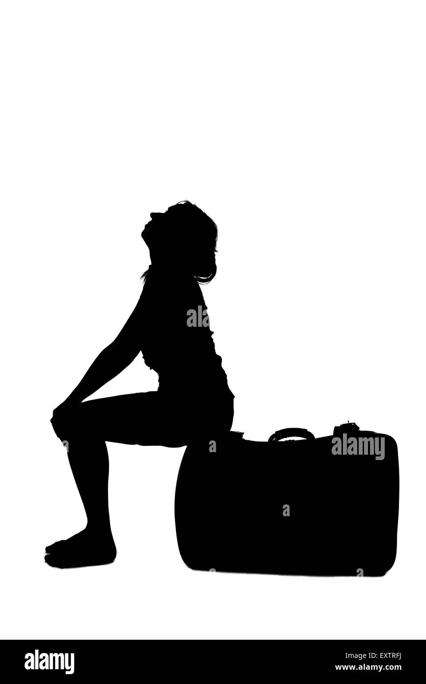 stressed woman silhouette - sitting on luggage Stock Photo