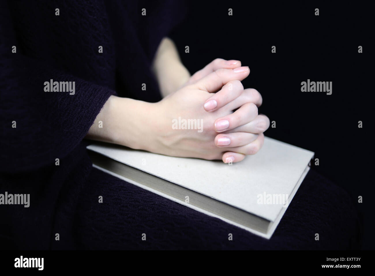 female hands on a closed book Stock Photo