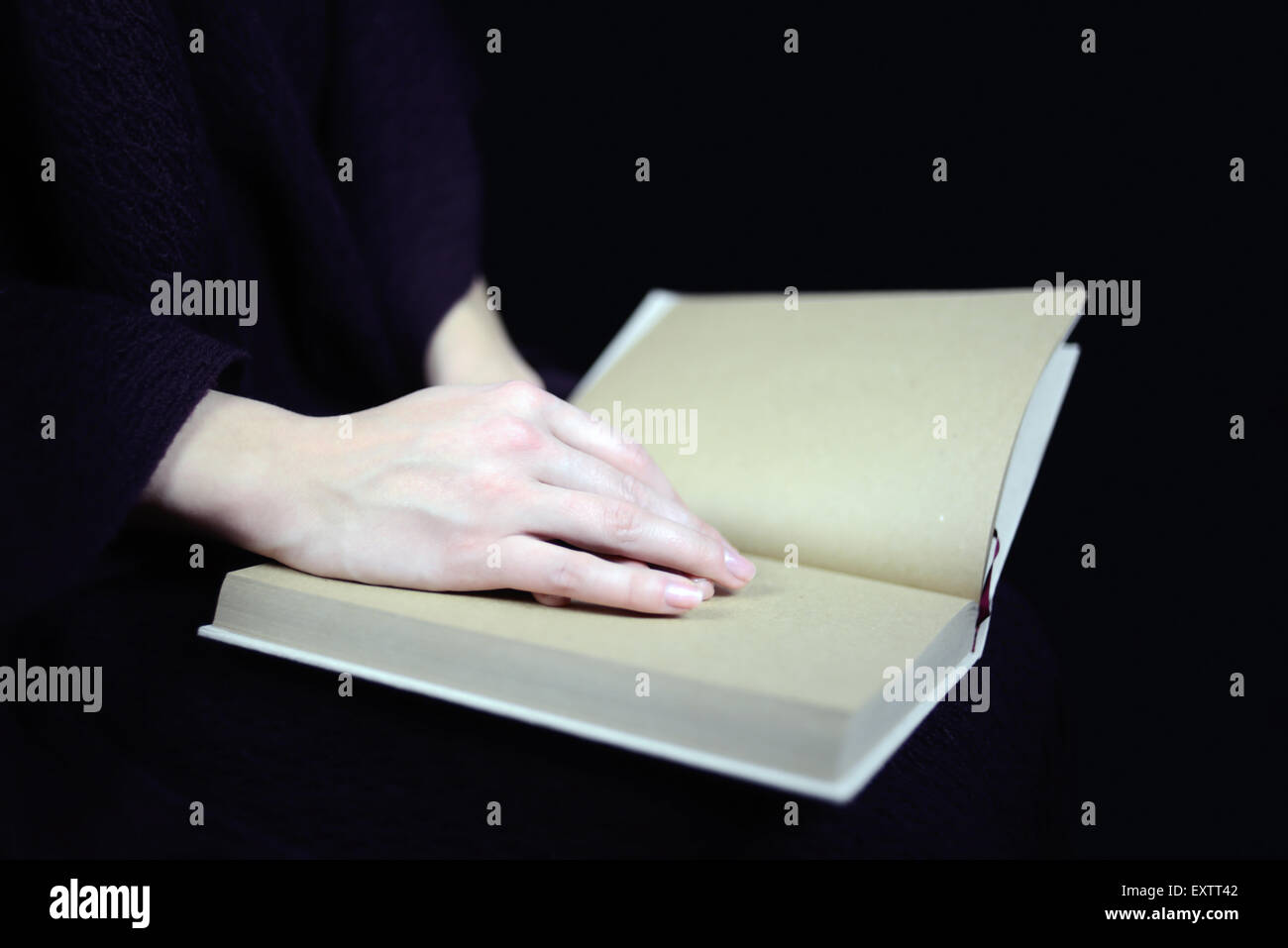 female hands on a closed book Stock Photo