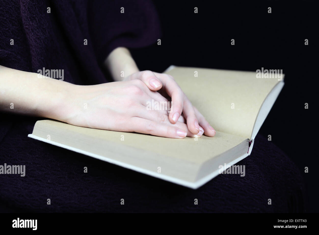 female hands on a closed book Stock Photo