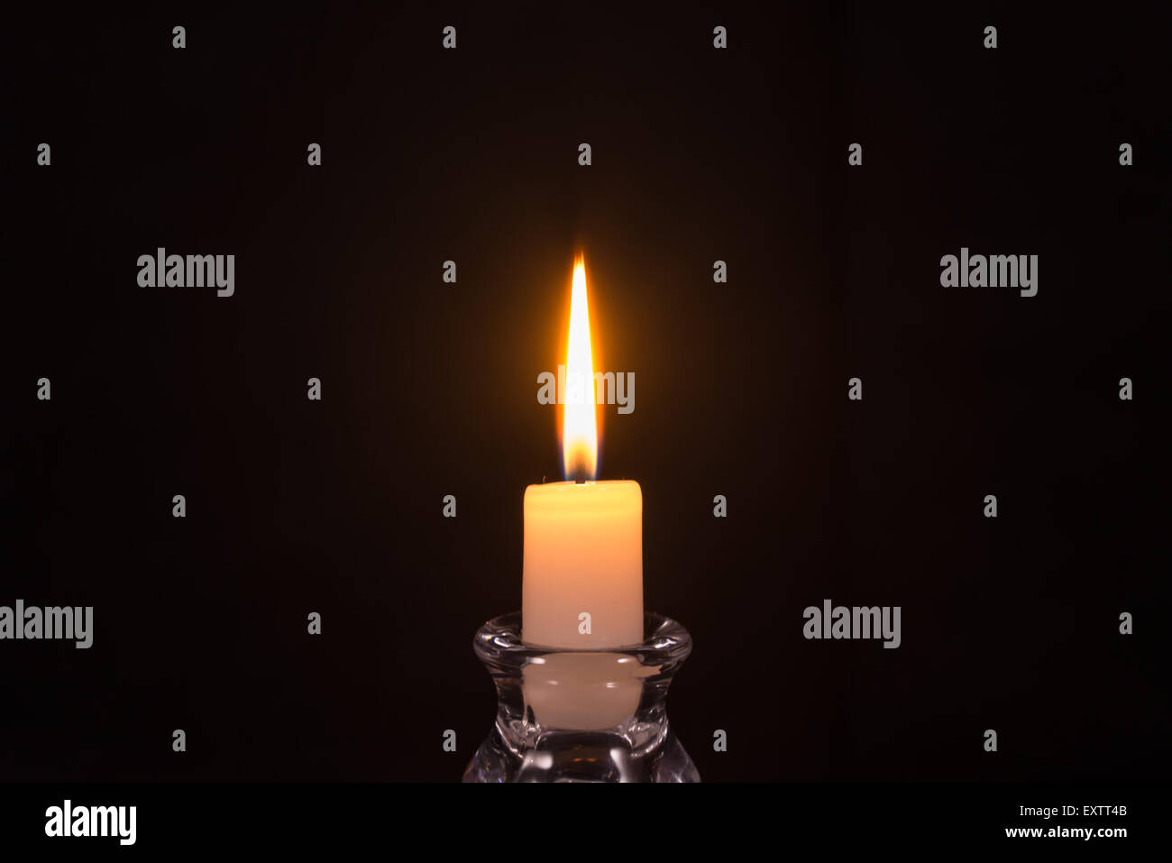 Burning white candle on a black background Stock Photo Alamy