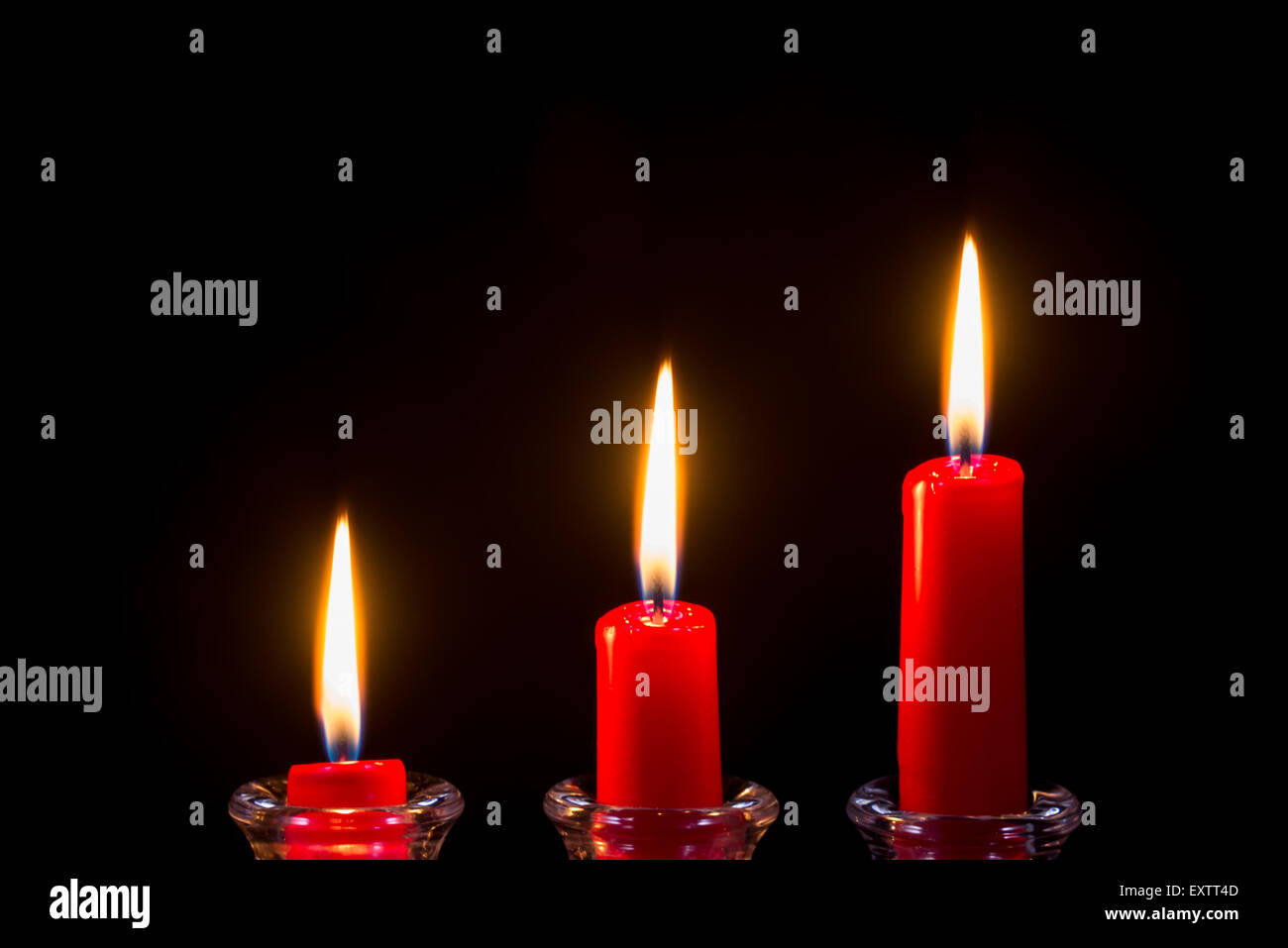 Three red candles on a black background Stock Photo Alamy