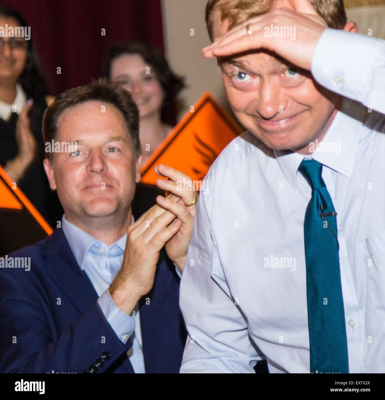 Islington Assembly Hall, London, July 16th 2015. The Liberal Democrats announce their new leader Tim Farron MP who was elected by party members in a vote against Norman Lamb MP. PICTURED: Out with the old, in with the new - former Liberal Democrat Leader Nick Clegg applaudes as Tim Farron takes to the podium to a burst of camera flashes. Credit:  Paul Davey/Alamy Live News Stock Photo