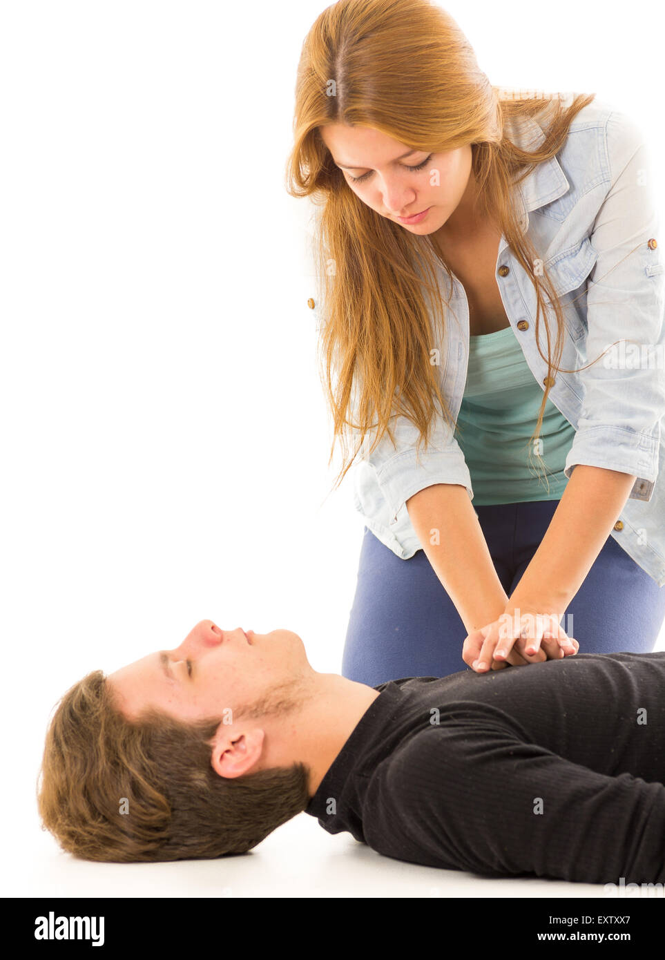 Couple demonstrating first aid techniques with woman applying cpr on male pattient lying down Stock Photo