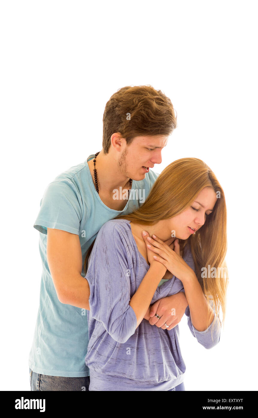 Couple demonstrating first aid procedure for abdominal thrusts, Heimlich Manoeuvre or Maneuver to treat choking by foreign objects Stock Photo