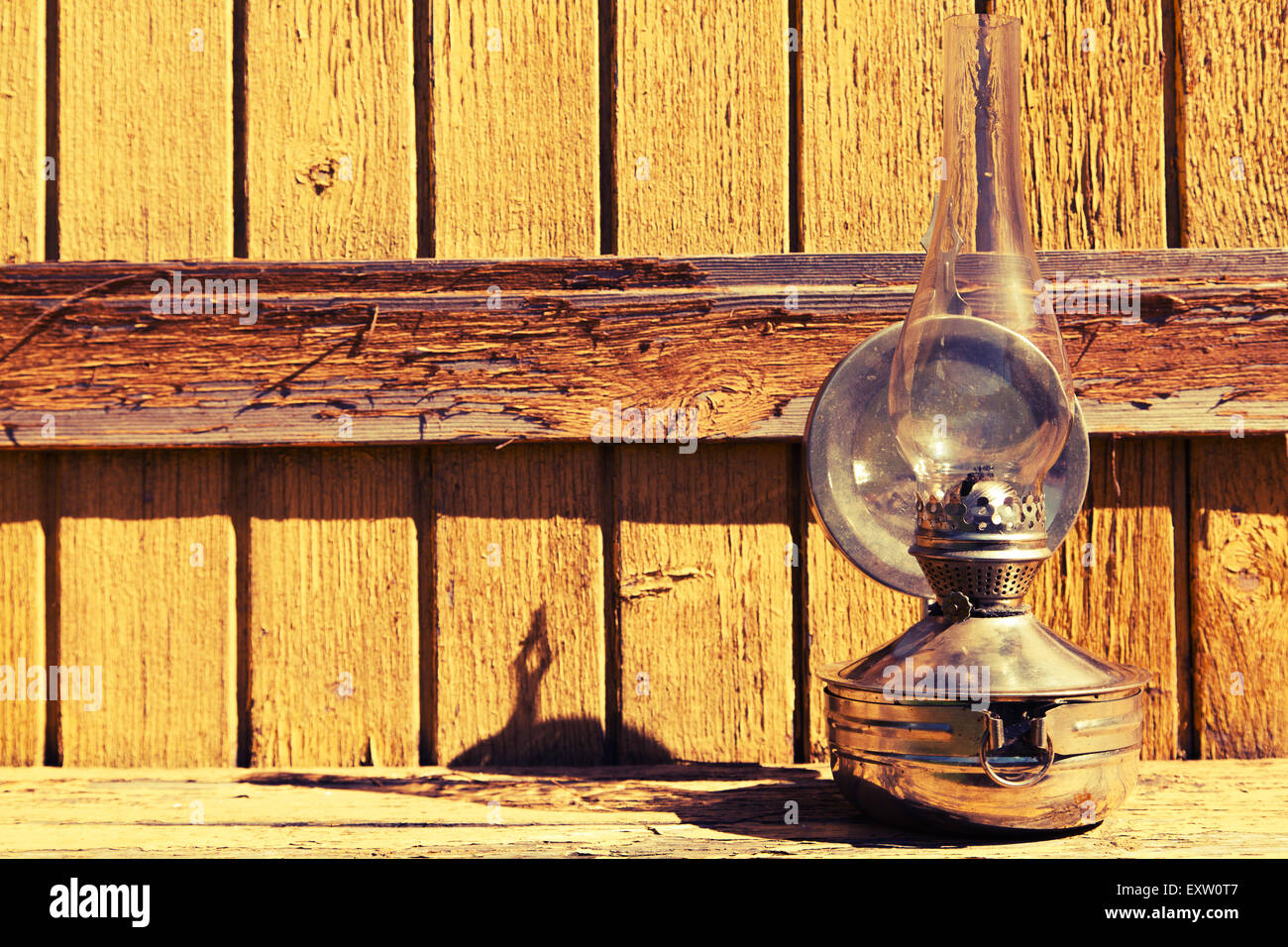 old kerosene lamp stands on wooden surface, outdoors Stock Photo Alamy