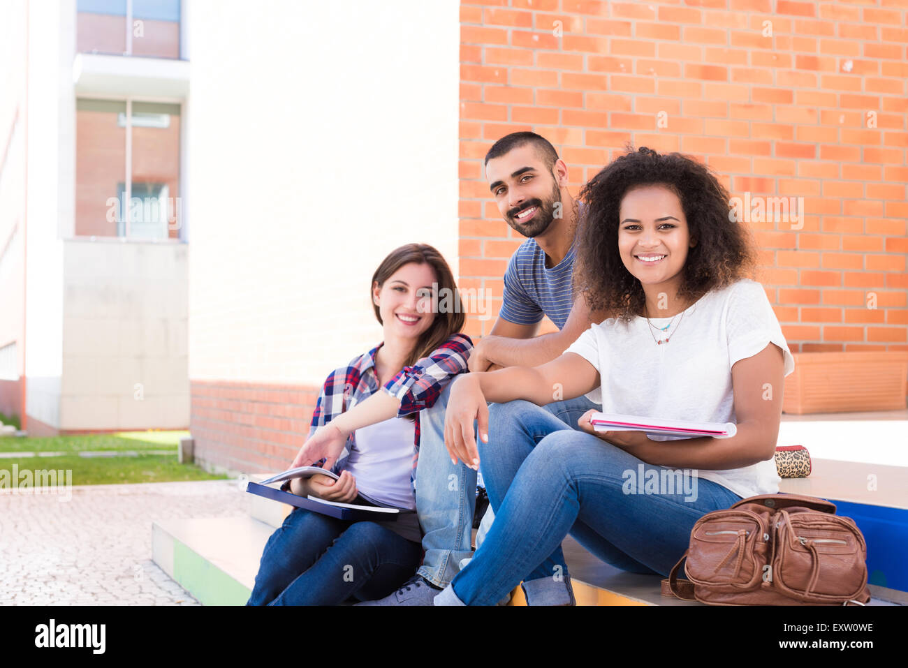 Group of students sitting on school stairs Stock Photo - Alamy
